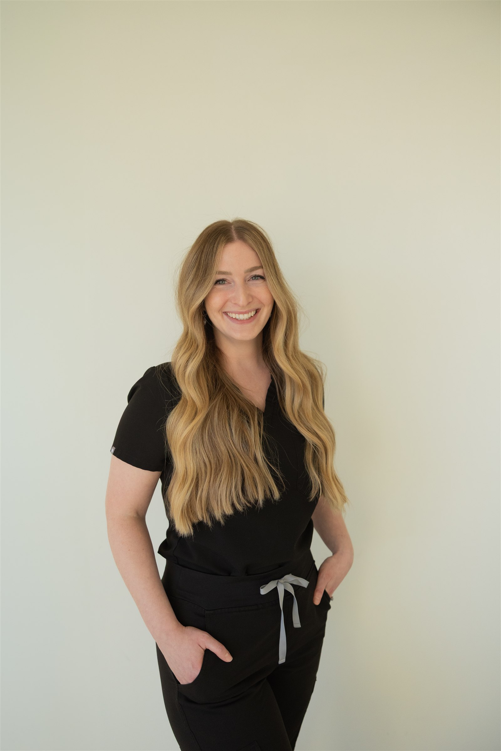 Madison Prim smiling in black clinical attire